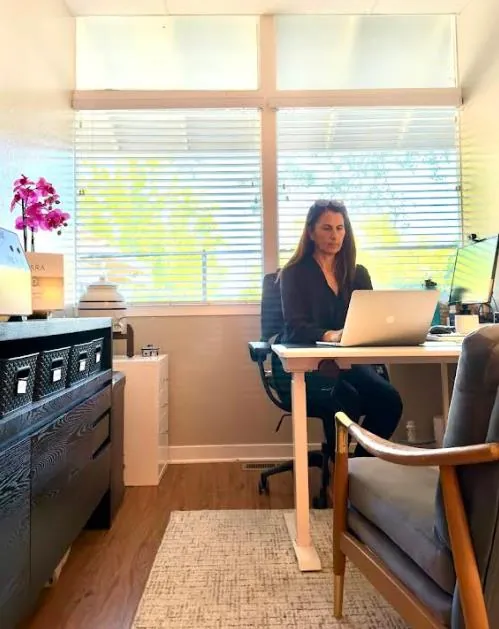 Dr. Samia McCully, ND at her desk in the Menlo Park office