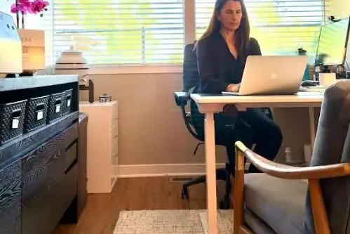 Dr. Samia McCully, ND working at her desk in the Menlo Park office